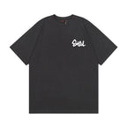 The T-shirt is an EVISU short-sleeve tee featuring a skull and large "M" print.