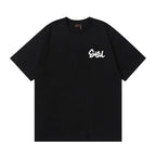 The T-shirt is an EVISU short-sleeve tee featuring a skull and large "M" print.