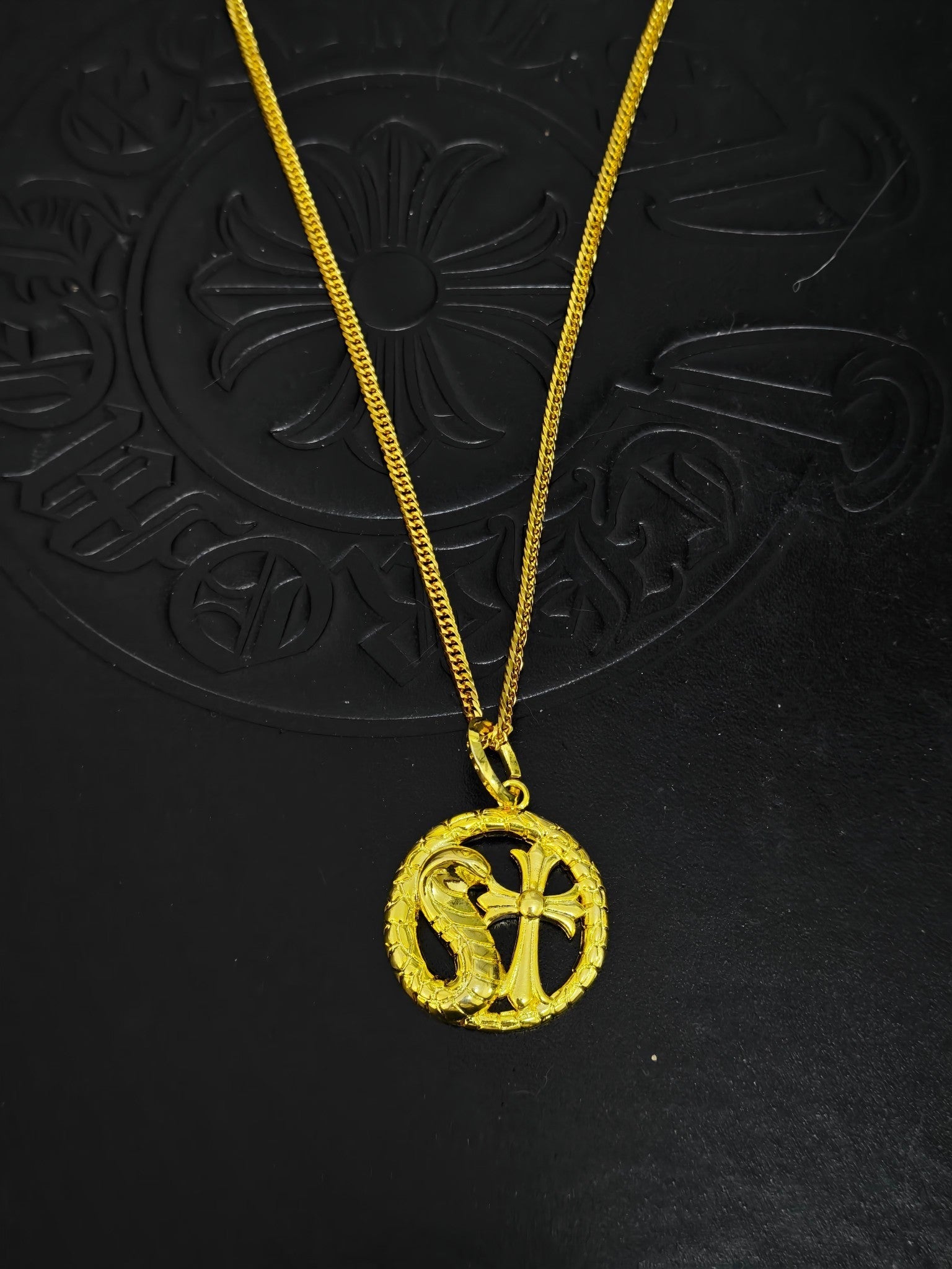 A snake-shaped cross necklace from Chrome Hearts.