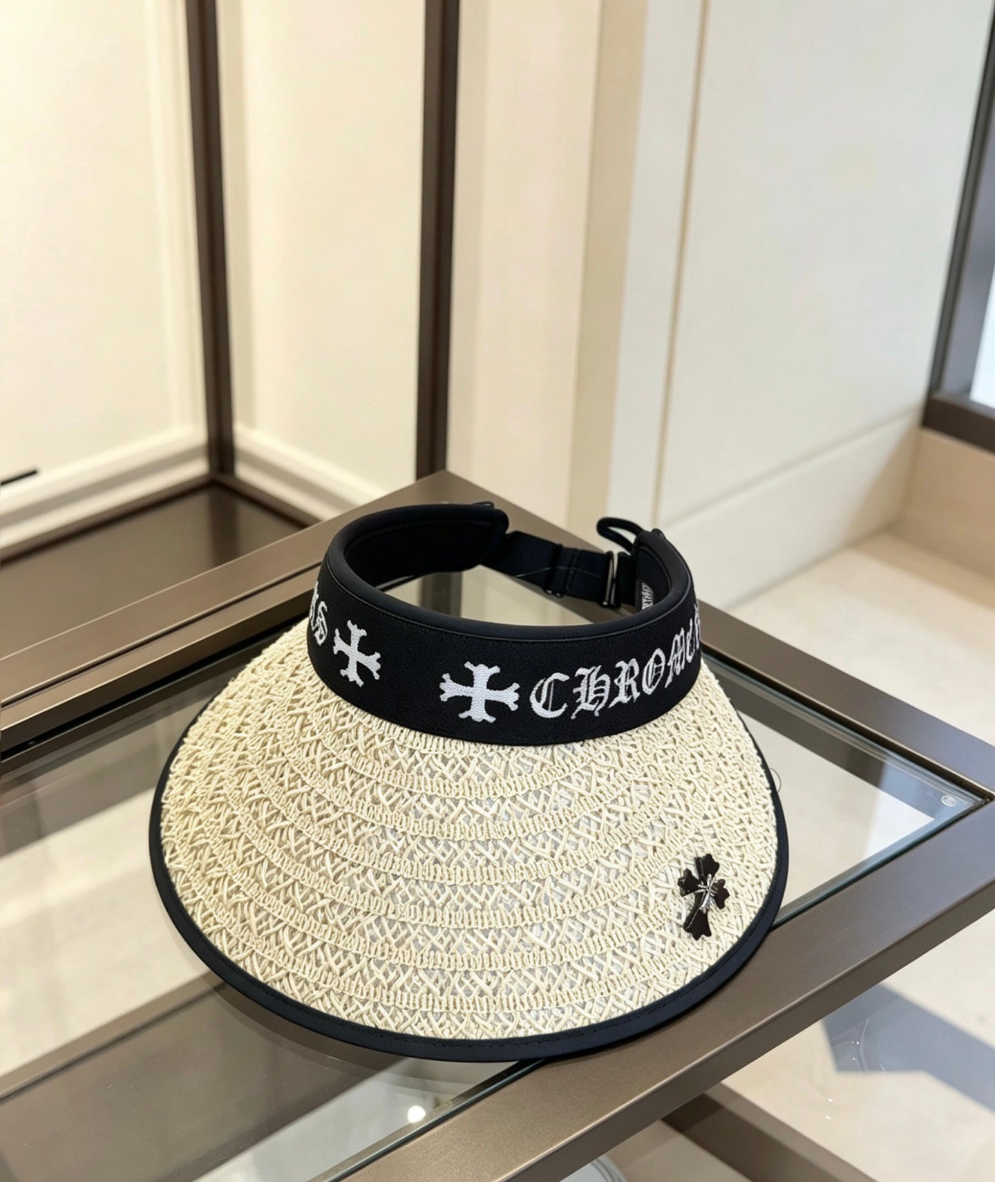 A black woven visor sun hat from Chrome Hearts.