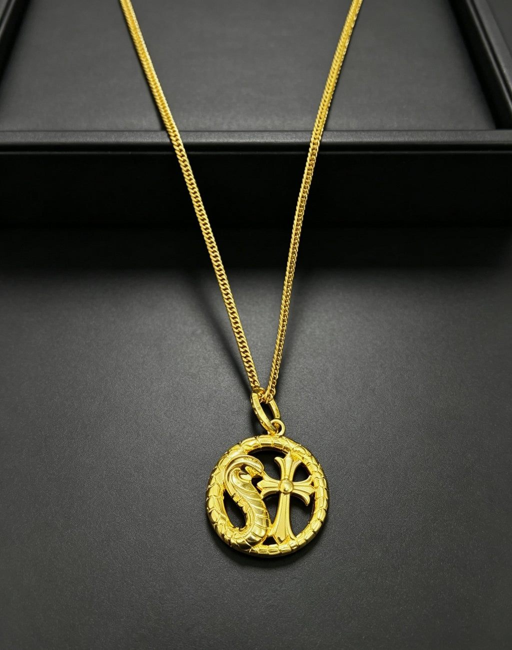 A snake-shaped cross necklace from Chrome Hearts.