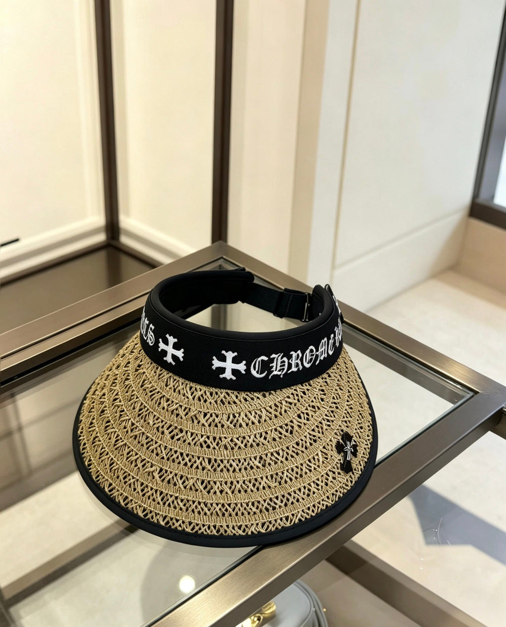 A black woven visor sun hat from Chrome Hearts.
