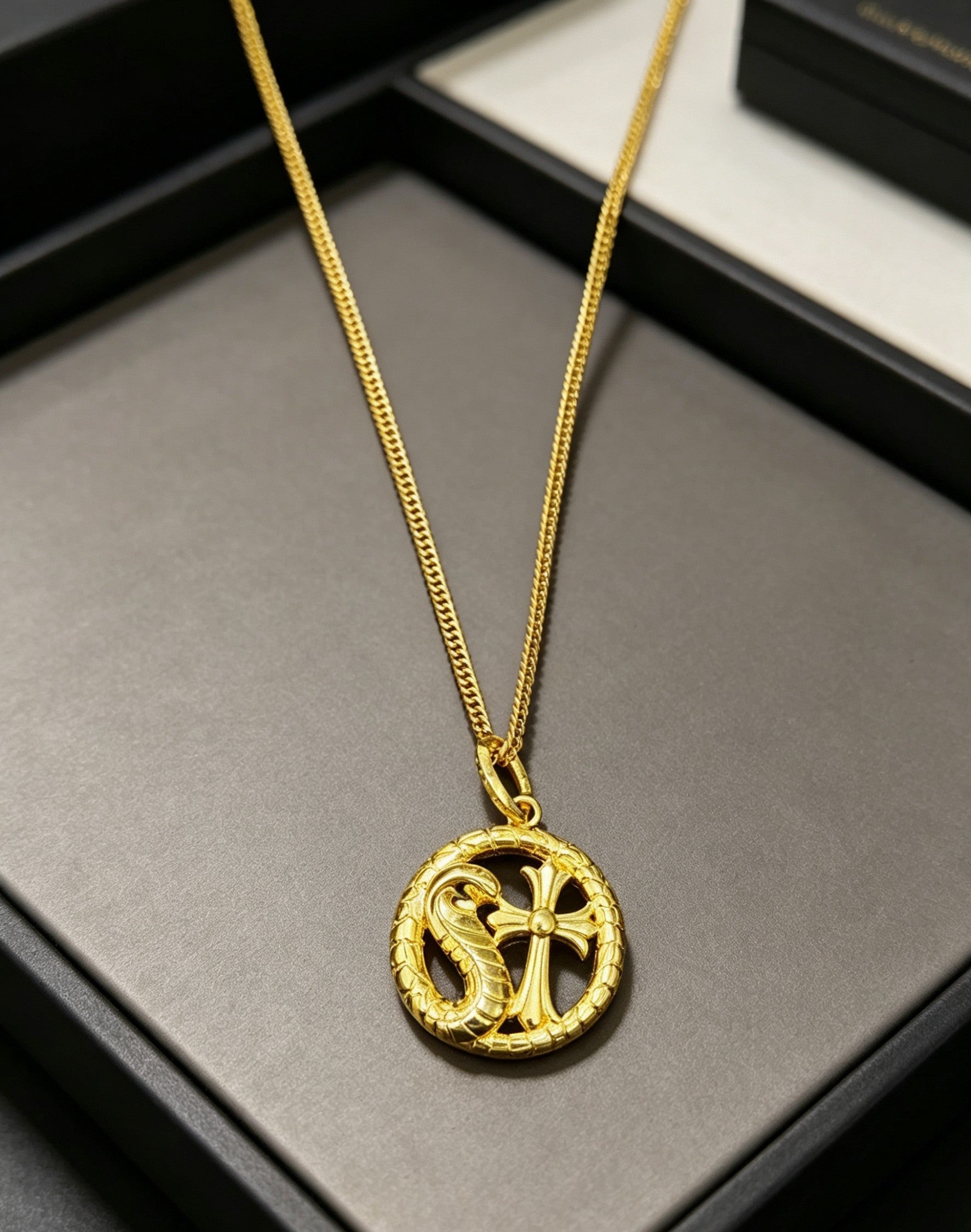 A snake-shaped cross necklace from Chrome Hearts.