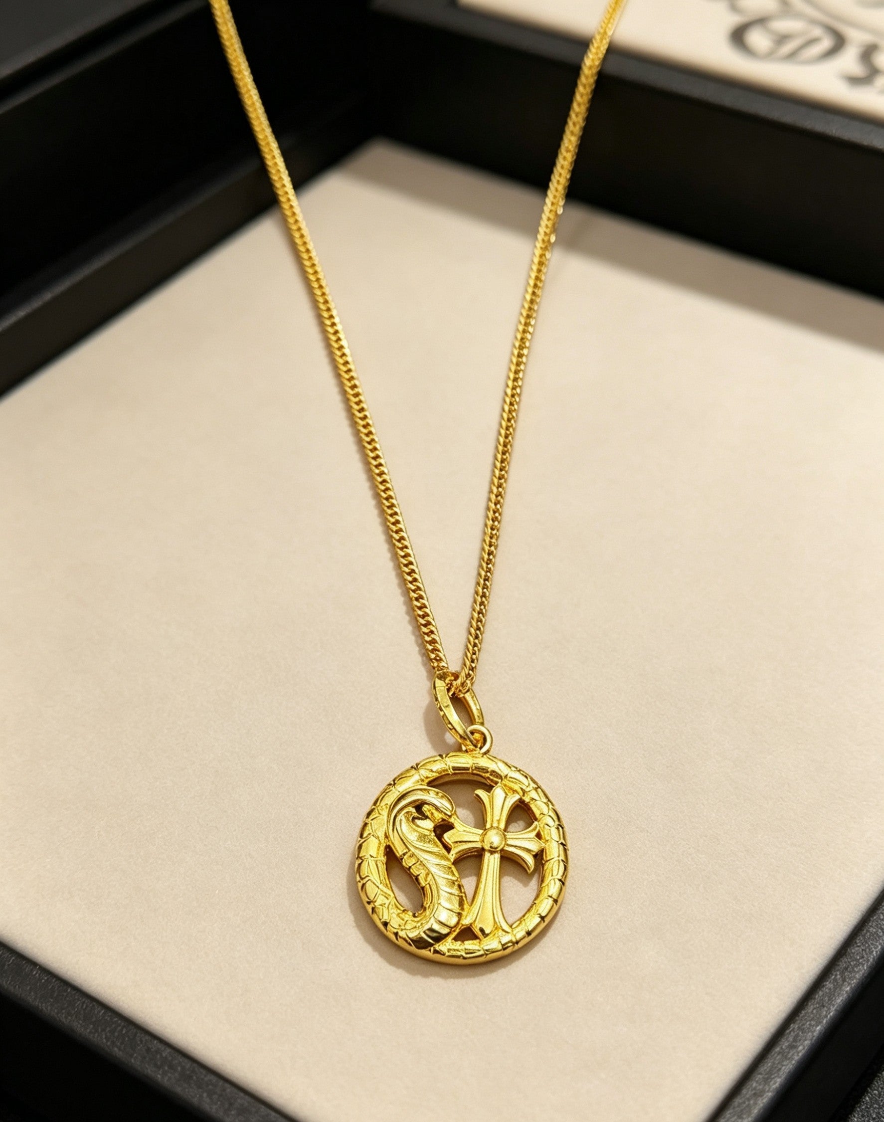 A snake-shaped cross necklace from Chrome Hearts.