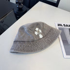 A grey washed denim bucket hat from Chrome Hearts.
