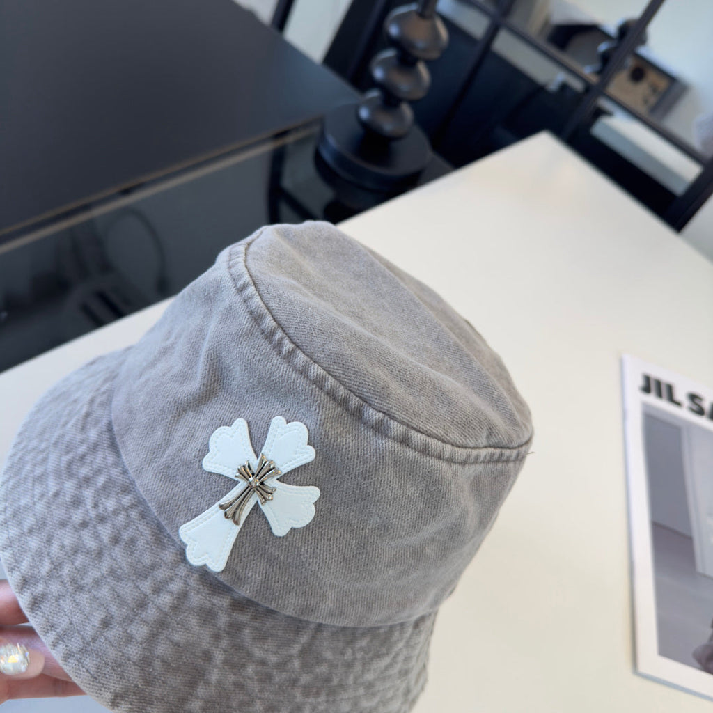 A grey washed denim bucket hat from Chrome Hearts.