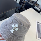 A grey washed denim bucket hat from Chrome Hearts.