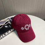 A burgundy baseball cap from Chrome Hearts.